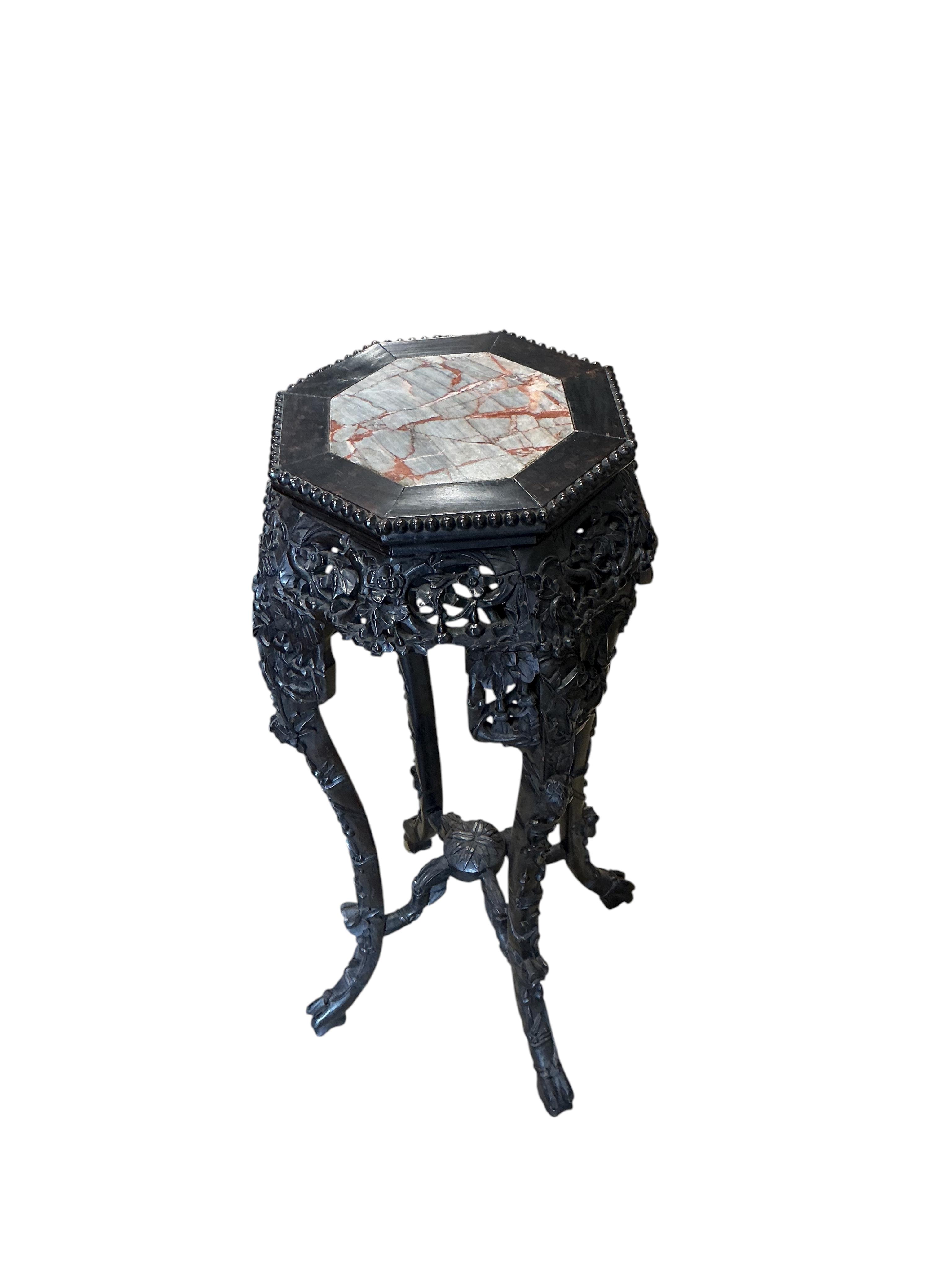 A Chinese marble topped octagonal vase stand, width 38cm, height 90cm